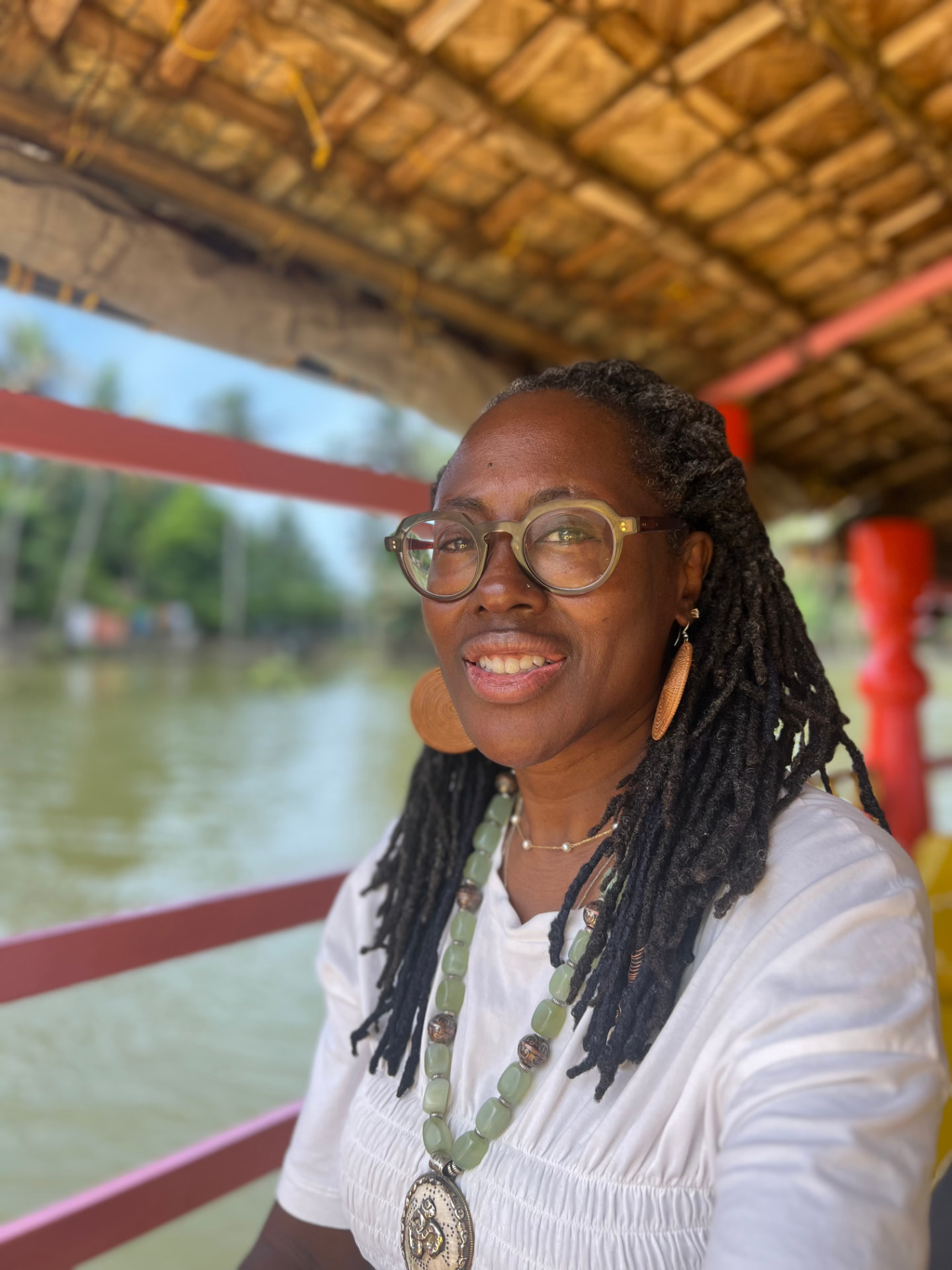 Dr. Makeba smiling aboard a boat in India